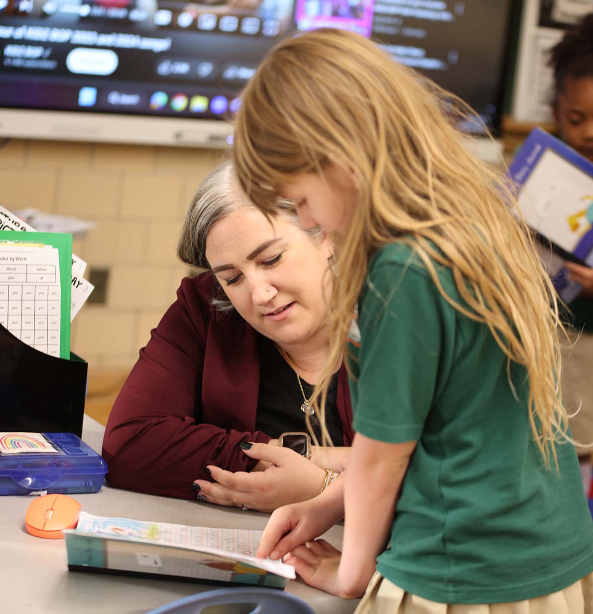 Student drawing in a classroom.